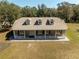 Aerial view of the charming home with dormer windows and front porch at 1773 Blue Oak Ct, Deland, FL 32720