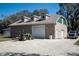 Exterior view of the property with a barn, a tractor, a well-maintained driveway, and a car, showcasing country living at 1773 Blue Oak Ct, Deland, FL 32720