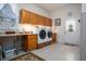Spacious laundry room with a large window, built-in cabinets, a front-load washer and dryer, and tiled flooring at 1773 Blue Oak Ct, Deland, FL 32720