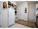 Pantry with a refrigerator, shelves, and a rug, offering plenty of storage for food and household items at 1773 Blue Oak Ct, Deland, FL 32720