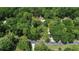 Aerial view showcases the home nestled in a mature landscape and nearby road at 1875 Glenwood Oaks Ln, Deland, FL 32720
