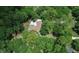 Aerial view features the house nestled in a mature landscape with long driveway at 1875 Glenwood Oaks Ln, Deland, FL 32720