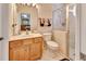 Bright bathroom with a glass-enclosed shower, marble vanity top and white toilet at 1875 Glenwood Oaks Ln, Deland, FL 32720