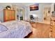 Bedroom with hardwood floors, work space, and access to an enclosed porch at 1875 Glenwood Oaks Ln, Deland, FL 32720