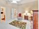 Cozy bedroom with carpet, a wood dresser, accent chair, and view of en-suite bathroom at 1875 Glenwood Oaks Ln, Deland, FL 32720