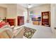 Comfortable bedroom with wood dresser, large TV, and leaf patterned rug at 1875 Glenwood Oaks Ln, Deland, FL 32720