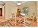 Cozy dining area featuring a round table, white chairs, and a bright window with natural light at 1875 Glenwood Oaks Ln, Deland, FL 32720