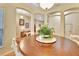 Open dining area with a large round table, white chairs, and elegant architectural details at 1875 Glenwood Oaks Ln, Deland, FL 32720