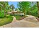 A long driveway leads to this charming one-story home with lush landscaping and mature trees at 1875 Glenwood Oaks Ln, Deland, FL 32720