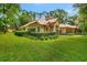 Well-kept lawn and landscaping accentuates this charming one-story home's exterior at 1875 Glenwood Oaks Ln, Deland, FL 32720