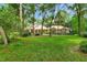 Beautiful one-story home featuring a sprawling green lawn, mature trees, and lush greenery at 1875 Glenwood Oaks Ln, Deland, FL 32720