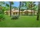 Beautiful one-story home with a lush lawn, mature trees, and manicured landscaping at 1875 Glenwood Oaks Ln, Deland, FL 32720
