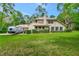 Exterior view of home, garage, lawn and parked RV at 1875 Glenwood Oaks Ln, Deland, FL 32720