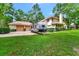 Spacious home with lush greenery, a three-car garage, and an RV parked in the driveway at 1875 Glenwood Oaks Ln, Deland, FL 32720