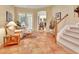 Inviting foyer with tile flooring, staircase, and French doors leading to another living space at 1875 Glenwood Oaks Ln, Deland, FL 32720