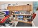 Attached garage includes upper and lower cabinets, pegboard, and a shop light for a functional workspace at 1875 Glenwood Oaks Ln, Deland, FL 32720