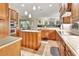 Spacious kitchen features wood cabinetry, granite countertops, stainless steel appliances, and a functional center island at 1875 Glenwood Oaks Ln, Deland, FL 32720