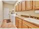 Functional laundry room with sink, ample counter space, and washer/dryer hookups at 1875 Glenwood Oaks Ln, Deland, FL 32720