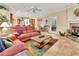 Bright living room with tile floors, fireplace, and views into kitchen and dining area at 1875 Glenwood Oaks Ln, Deland, FL 32720
