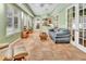 Spacious living area with tile flooring, French doors, and green walls, perfect for relaxation at 1875 Glenwood Oaks Ln, Deland, FL 32720