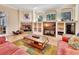 Cozy living room with fireplace, built-in shelving, and large windows at 1875 Glenwood Oaks Ln, Deland, FL 32720