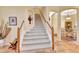 Elegant staircase with carpeted steps and wood railings leads to the upper level at 1875 Glenwood Oaks Ln, Deland, FL 32720