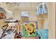 Organized walk-in closet with shelves and rods, featuring a sunflower painting on the floor at 1875 Glenwood Oaks Ln, Deland, FL 32720