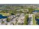 Aerial view of a residential area surrounded by lush greenery, a golf course, and sparkling lakes at 2015 Cornell Pl, Port Orange, FL 32128