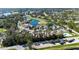 Overhead shot of the property showcasing the manicured landscaping, community pool, and proximity to a lake at 2015 Cornell Pl, Port Orange, FL 32128
