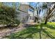 A beautifully maintained lawn and a screened-in porch offer a relaxing outdoor living area at 2015 Cornell Pl, Port Orange, FL 32128