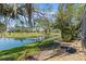 View of the backyard with a serene pond and lush landscaping, creating a tranquil outdoor space at 2015 Cornell Pl, Port Orange, FL 32128