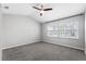 Spacious bedroom featuring a ceiling fan, neutral walls, and two bright windows at 2015 Cornell Pl, Port Orange, FL 32128