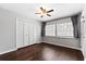 Bedroom with hardwood floors, ceiling fan, large closet, and window with blinds and curtains at 2015 Cornell Pl, Port Orange, FL 32128