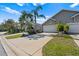 Landscaped front yard with palm trees enhancing the curb appeal of this cozy single Gathering home at 2015 Cornell Pl, Port Orange, FL 32128