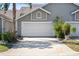 A beautiful home with a large, white garage door framed by lush landscaping, adding to its curb appeal at 2015 Cornell Pl, Port Orange, FL 32128