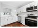 Bright kitchen showcasing stainless steel appliances, white cabinetry, and a modern design at 2015 Cornell Pl, Port Orange, FL 32128
