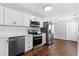 Bright kitchen featuring stainless steel appliances, white cabinets and a white subway tile backsplash at 2015 Cornell Pl, Port Orange, FL 32128