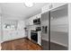 Modern kitchen with stainless steel appliances, white cabinets, quartz countertops and wood flooring at 2015 Cornell Pl, Port Orange, FL 32128