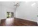 Open living room with gleaming hardwood floors, and sliding doors opening to a patio at 2015 Cornell Pl, Port Orange, FL 32128