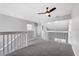 Bright loft area with neutral walls, carpet flooring, and a ceiling fan at 2015 Cornell Pl, Port Orange, FL 32128