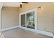 Tiled patio with sliding glass doors offering serene lake views at 2015 Cornell Pl, Port Orange, FL 32128