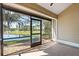 Screened-in patio offering scenic lake views and a tiled floor at 2015 Cornell Pl, Port Orange, FL 32128