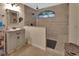 This bathroom features a luxurious walk-in shower with tiled walls, a window, and a vanity at 238 Crooked Tree Trl, Deland, FL 32724