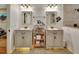 This bathroom features double sink vanities with neutral cabinets and elegant lighting at 238 Crooked Tree Trl, Deland, FL 32724