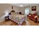 Comfortable bedroom decorated with dark wood furniture, a patterned bedspread, and bright window at 238 Crooked Tree Trl, Deland, FL 32724