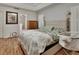 This bedroom features wood floors, neutral walls, a comfortable bed, and a vintage wood dresser at 238 Crooked Tree Trl, Deland, FL 32724
