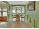 Cozy dining area features a bay window, chandelier, and green accent walls at 238 Crooked Tree Trl, Deland, FL 32724