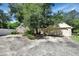 Spacious driveway leading to a two-car garage, surrounded by lush greenery and mature trees at 238 Crooked Tree Trl, Deland, FL 32724