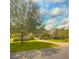 Inviting single story home with well maintained lawn, mature trees, and brick accents on driveway and covered walkway at 238 Crooked Tree Trl, Deland, FL 32724