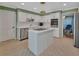 Well-lit kitchen with white cabinets, stainless steel appliances, and a center island at 238 Crooked Tree Trl, Deland, FL 32724